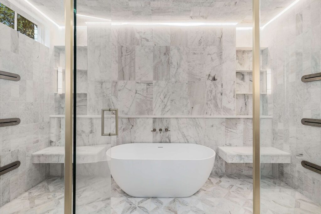 Primary bathroom with freestanding soaking tub and marble surround in a custom home built by VIBE Luxury Homes in Brookhaven, Atlanta