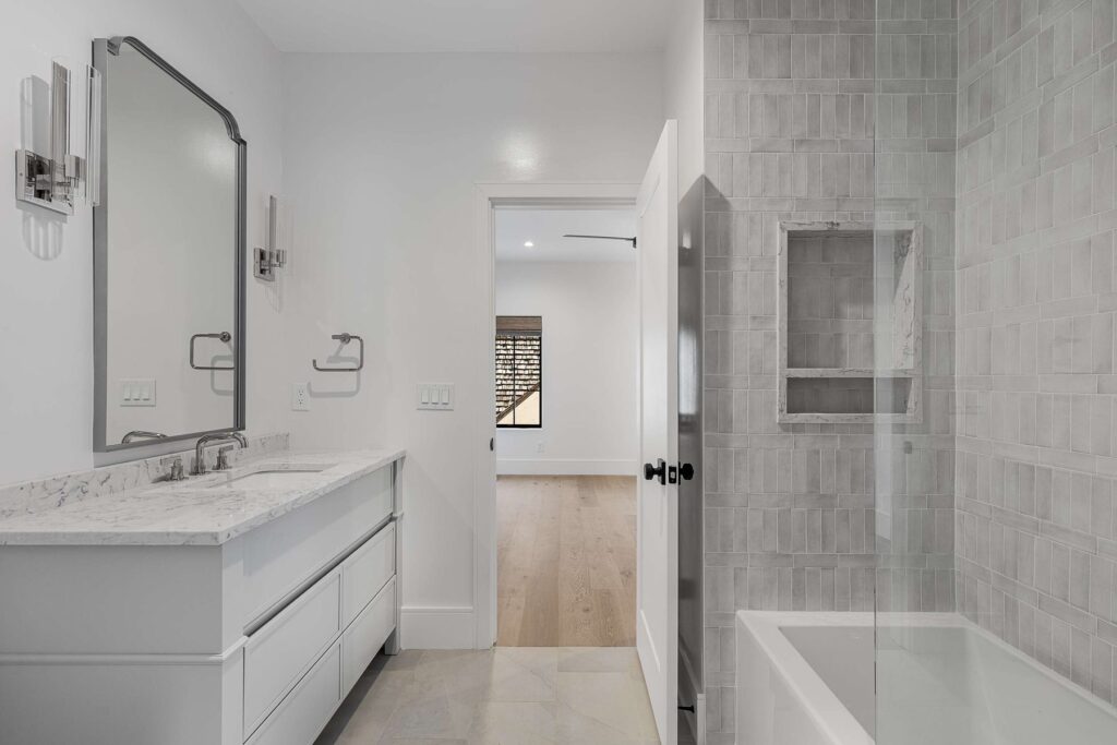 Primary bathroom double vanity with arched mirrors in a custom home built by VIBE Luxury Homes in Brookhaven, Atlanta