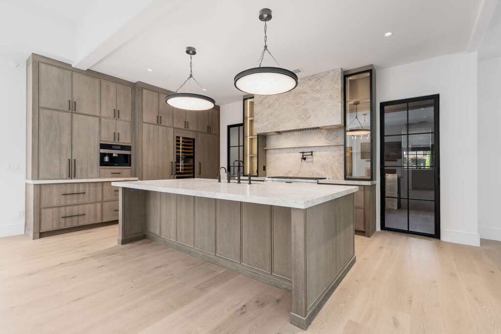 Kitchen island with pendant lighting in a custom home built by VIBE Luxury Homes in Brookhaven, Atlanta