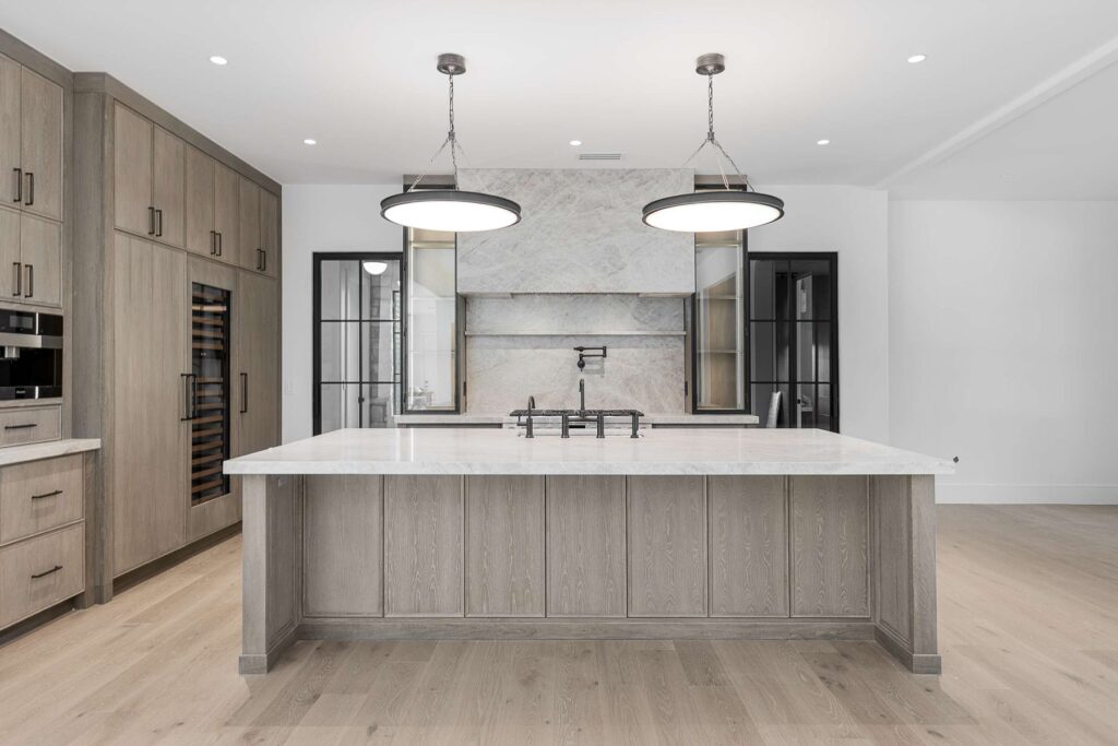 Chef’s kitchen with marble counters in a custom home built by VIBE Luxury Homes in Brookhaven, Atlanta