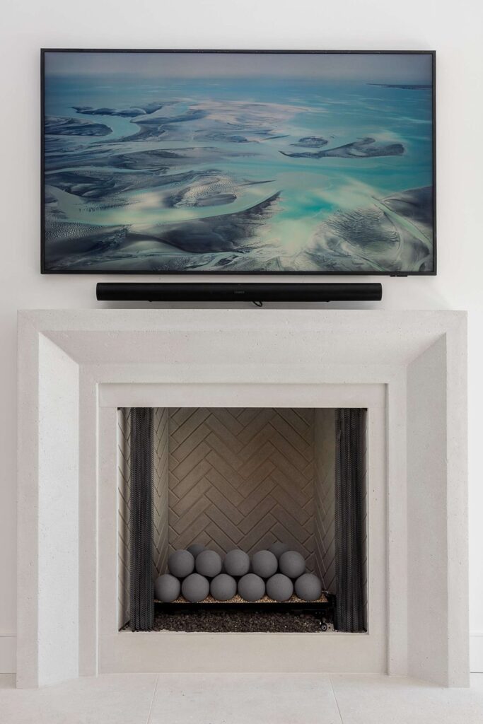 Living room fireplace with marble surround in a custom home built by VIBE Luxury Homes in Brookhaven, Atlanta