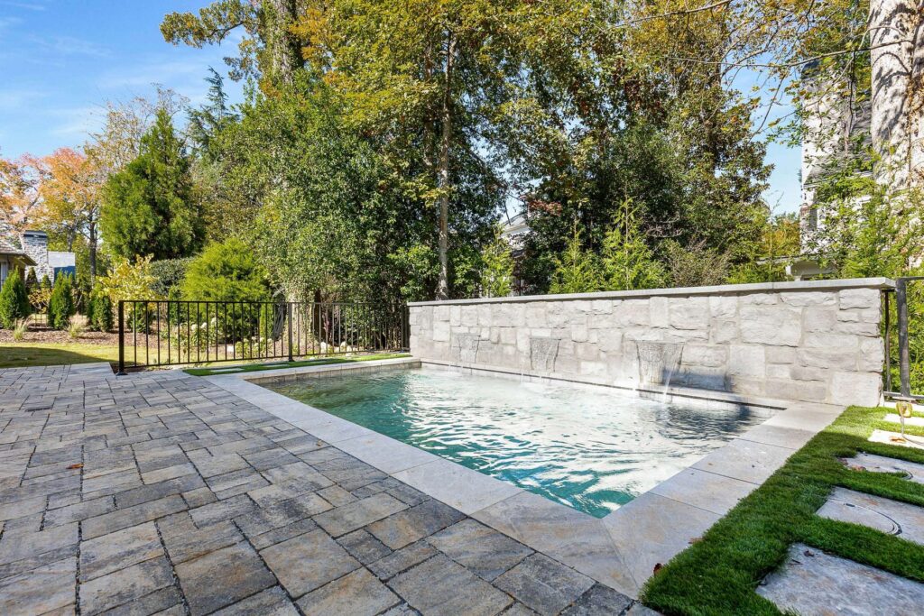 Pool, paver terrace and landscape design at a custom home built by VIBE Luxury Homes in Brookhaven, Atlanta