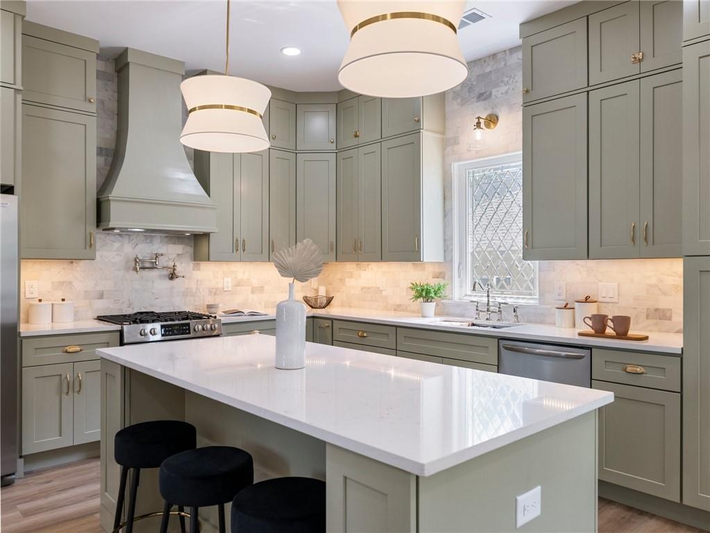 Sage green kitchen with marble backsplash and island, Dill custom home