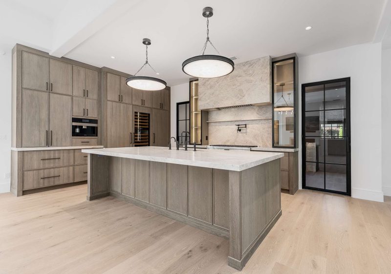 Kitchen island with pendant lighting in a custom home built by VIBE Luxury Homes in Brookhaven, Atlanta