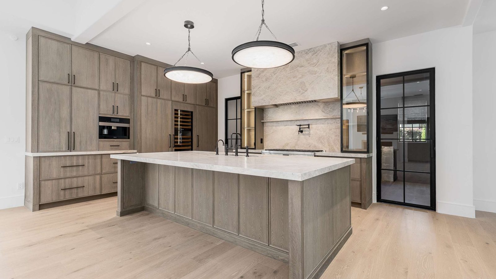 Kitchen island with pendant lighting in a custom home built by VIBE Luxury Homes in Brookhaven, Atlanta